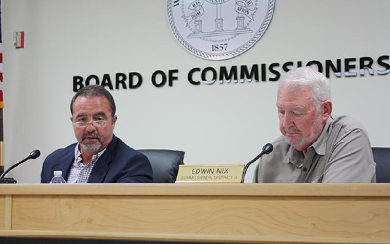 Chairman Travis Turner and Commissioner Edwin Nix discuss Sullivan Wickley’s request to rezone land off of Ed Lewis Road. (Photo/Eric Tiongson)