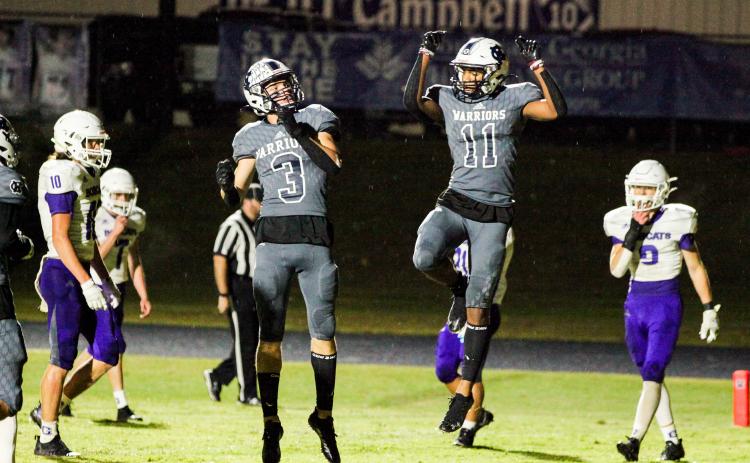 Bryson Cronic, left, and Darius Cannon celebrate after a touchdown during the Warriors' region win over Gilmer County last Friday in Cleveland. (Photo/Staci Sulhoff)