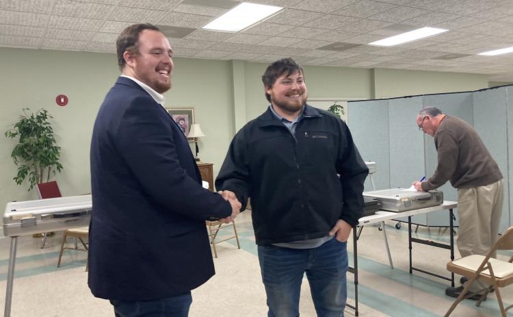 From left, CJ McDonald and Jeremy McClure shake hands after the unofficial vote totals showed them as winners in the Cleveland City Council elections. (Photo/Wayne Hardy)