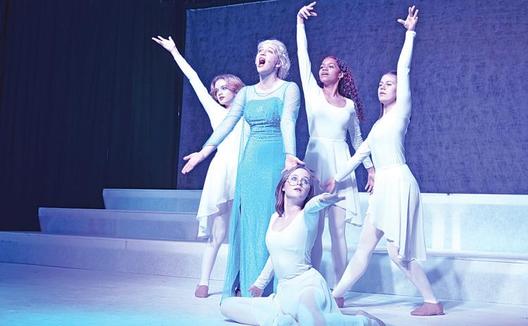 Leah Smith as Elsa sings “Let it Go” as dancers Grace Reyes, Kelsey Cleveland, Elizabeth Himstedt and (sitting) Bella Whitaker show her ice powers. (Photo/Samantha Sinclair)