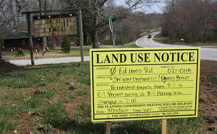 A sign placed off of Ed Lewis Road gives information about the public hearing. A Dollar General store is proposed for the property, requiring a zoning change. (Photo/Eric Tiongson)
