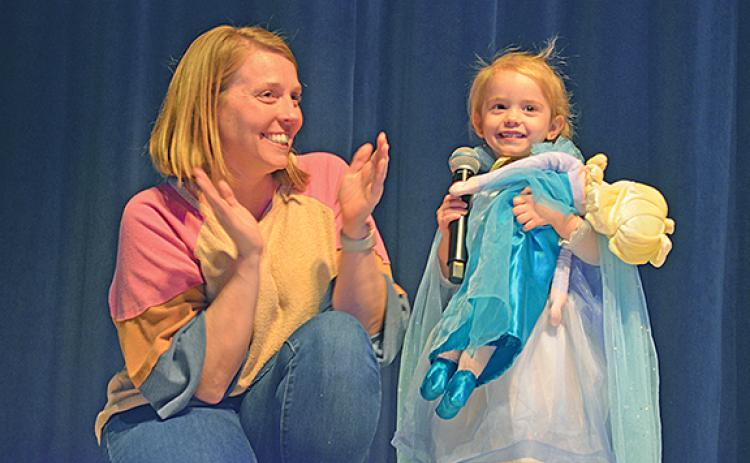 Satana Dockery claps along as her daughter, Ellie Kate, sings “Let it Go” from “Frozen” at the It Only Takes a Spark Talent Show. The three-year-old was the youngest performer. (Photos/Samantha Sinclair)