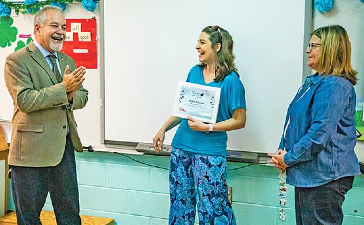 State Superintendent Richard Woods surprises Tesnatee Gap Elementary School Teacher Holly Witcher with the news that she is one of the ten finalists for Georgia Teacher of the Year as White County Schools Superintendent Laurie Burkett looks on. (Photo/Georgia Department of Education)