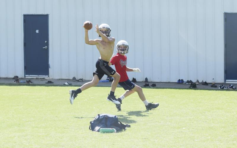 Cam Wilson, left, jumps in front of receiver Trevor Butler to pick off a pass during a one-on-one drill Tuesday morning at the White County Middle School stadium. (Photo/Mark Turner)