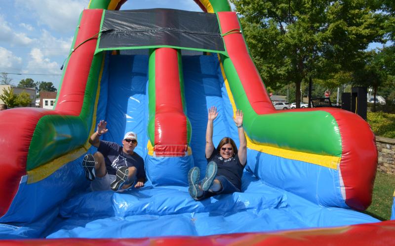 It was a battle of the superintendents as Dr. Laurie Burkett and Scott Justus raced each other down the bouncy slide at the block party held by the White County School System on Sunday, Sept. 15. More photos from the event are in this week's White County News. (Photo/Stephanie Hill)