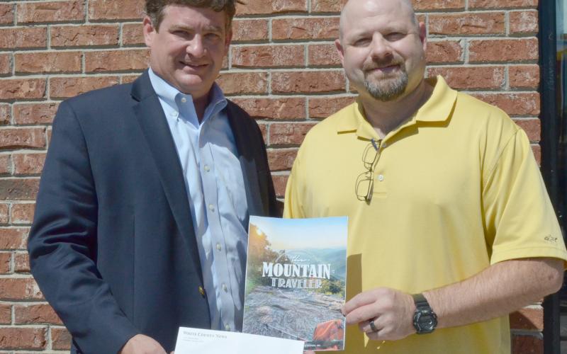 Community Newspapers Inc. Regional Publisher Alan NeSmith (left) presents Joe Gralton of Cleveland with the $100 prize for winning the cover photo contest for fall 2019 edition of The Mountain Traveler. (Photo/Stephanie Hill)