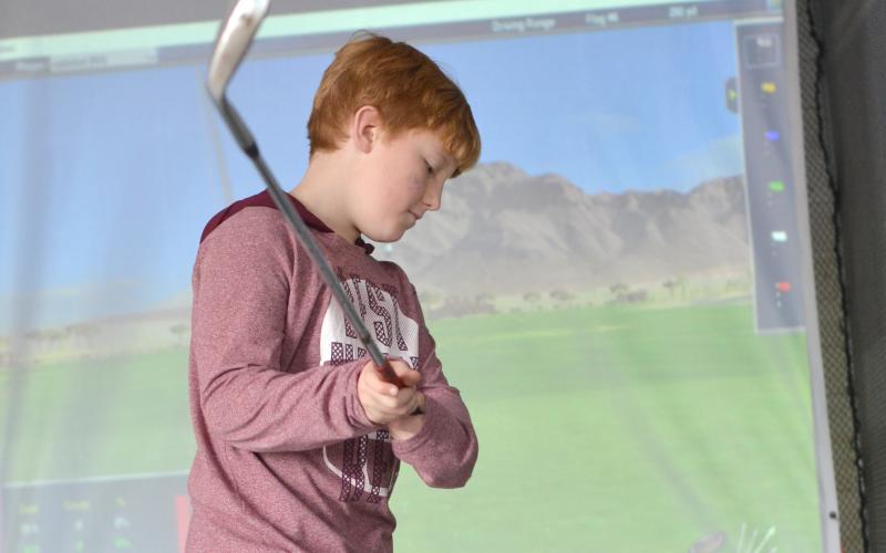 Camden Mincey of Sautee tries the golf simulator.