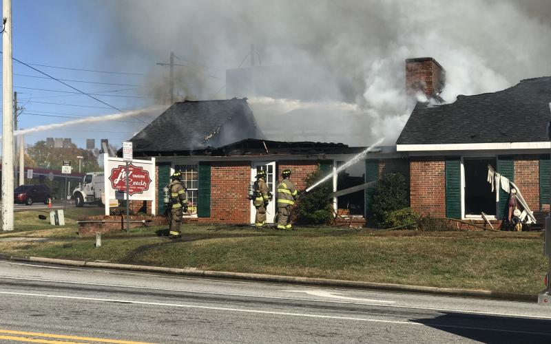Firefighters work to extinguish the flames at J.W. Reeds Tavern. (Photo/Stephanie Hill)