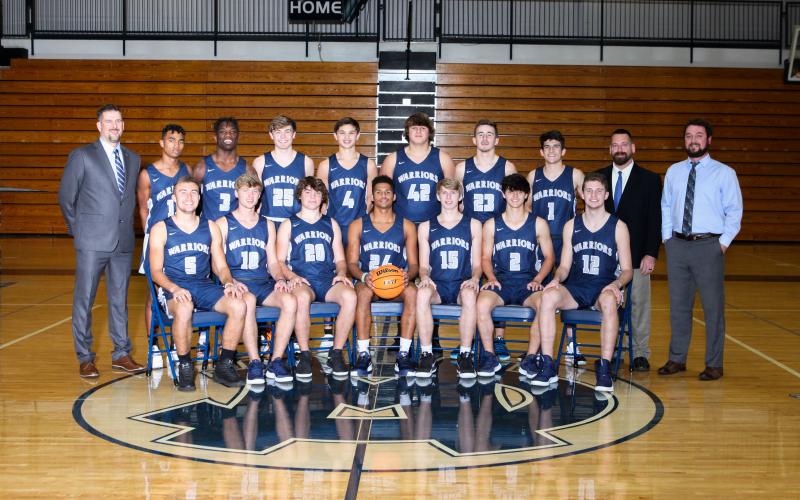 Members of the White County Warriors basketball team are, front from left, Reece Dockery, Rylee Higgins, Alex Thornton, Will Sampson, Marty James, Dylan Sargent, and Jimmy King; back row, head coach Wade Mawdesley, Darius Cannon, Silas Mulligan, Kenny Simpson, Jadon Yeh, JD Trowell, Cooper Turner, Riley Egerton, assistant coach Robbie Bailey, and assistant coach Chris Black. (Photo/Staci Sulhoff)