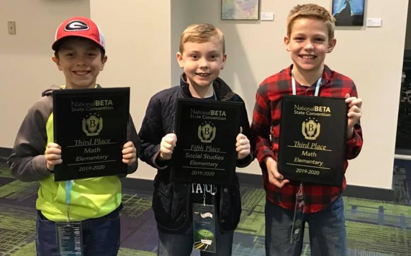 Mossy Creek students Hunter Moyers, Brody Kelley and Zachary Godfrey all proudly hold up their awards from the state competition last week in Savannah. (Submitted photos)