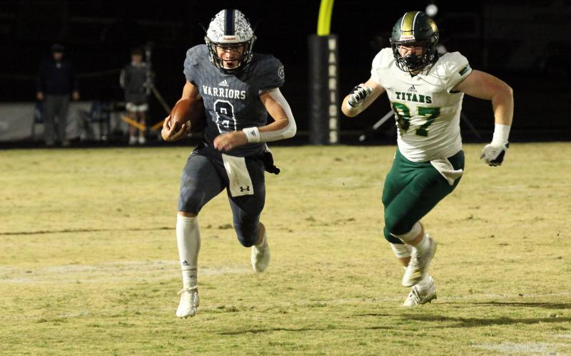 WCHS quarterback J. Ben Haynes runs away from Blessed Trinity's Grayson Gilder during the regular season finale in November.Haynes was a 7-AAAA All-region pick this season after leading the region in passing yardage and total touchdowns. (Photo/Staci Sulhoff)
