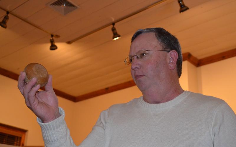 Charlie Thomas holds up a game stone that he presented at the show and tell program at the White County Historical Society meeting last week. More photos from the event are in this week's White County News. (Photo/Stephanie Hill)