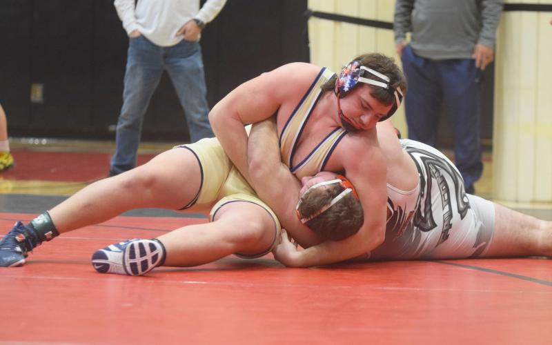 White County's Devin Sullens pins Flowery Branch's Clayton Walczuk to win the Region 7-AAAA championship match in the 285-pound division. Sullens had a pair of pins during the region tournament last Saturday at Flowery Branch High School, and earned a spot in the Class AAAA sectionals this weekend in Perry. (Photo/Mark Turner)