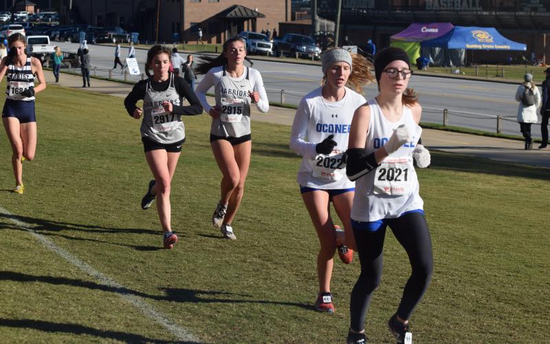 Paced by Sydnee Nix, left, and Ellie Gearing, the Lady Warriors posted a fifth-place finish at the Class AAAA state cross country meet last fall, the highest state finish for a WCHS this year. (Photo/Mark Turner)