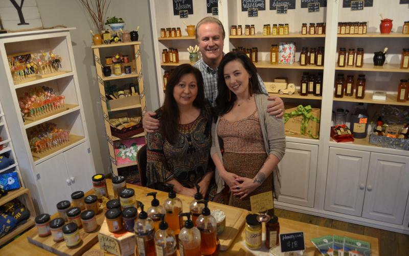Honey on the Hill owners Anna and Dale Fisher pose with store employee Abigail Thomas in the company’s first retail location in Helen. (Photo/Wayne Hardy)