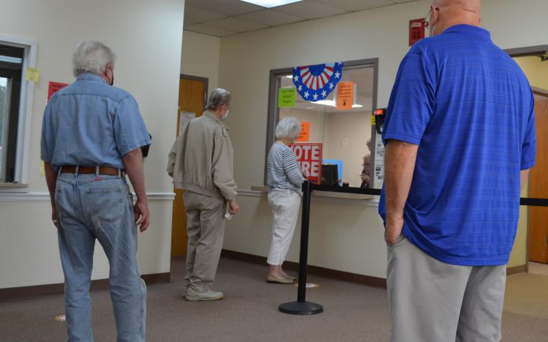 Voters arranged in a socially distanced line wait to cast their ballot Tuesday at the White County Voter Registrar’s Office. (Photo/Stephanie Hill)