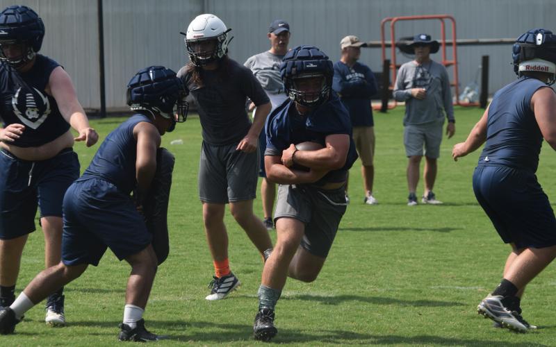 Riley Stancil heads up the field during Tuesday's workout at the WCHS football facility. (Photo/Mark Turner)