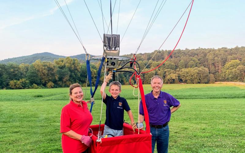 J.T. Head III, center, is now the world’s youngest pilot at only 8 years old flying a specially designed hot air balloon flying over Sautee Nacoochee. He’s shown with parents Desiree and Tarp Head. (Photos courtesy/Tarp Head)