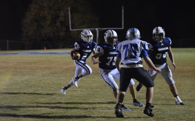 Noah Williams, No, 30, and Dade Anderson, No. 75, clear the way for Tripp Nix on a touchdown run during the second half of the Mountain Athletic Conference championship game Saturday night in Cleveland. (Photos/Mark Turner)