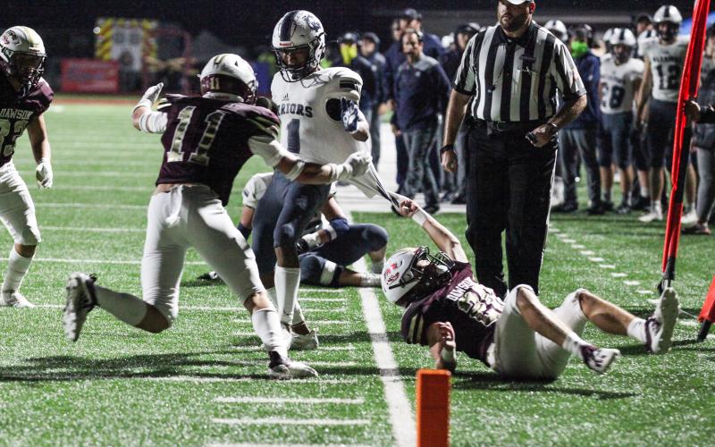 Dawson County's Hayden McKinney, left, and Tripp Caine stop White County's Darius Cannon a few yards short of the end zone during the first half of the Region 7-AAA opener last Friday night in Dawsonville. (Photo/Mark Turner)