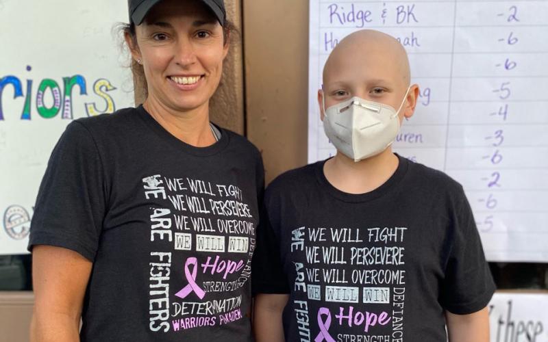 Esta Johnson, left, and Kaden Wilson show of the T-shirts that are being sold to support Wilson and his family. (Photo/Esta Johnson)