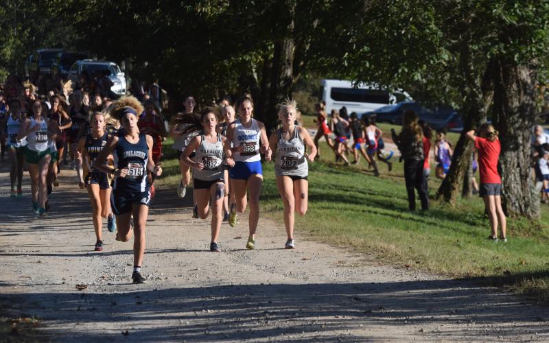 White County's Sydnee Nix, left, and Nealeigh Broadwell, right, keep pace with Oconee County's Molly Meeks during the opening mile of the race. (Photo/Mark Turner)