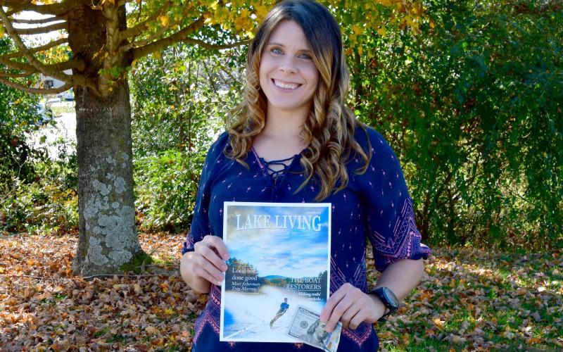 Heather Conner of Clayton holds a copy of her photograph of a water skier, which graces the cover of the winter 2020 edition of Lake Living magazine. In addition to having her photograph on the magazine’s cover, Conner won $100. (Photo/Kimberly Brown)