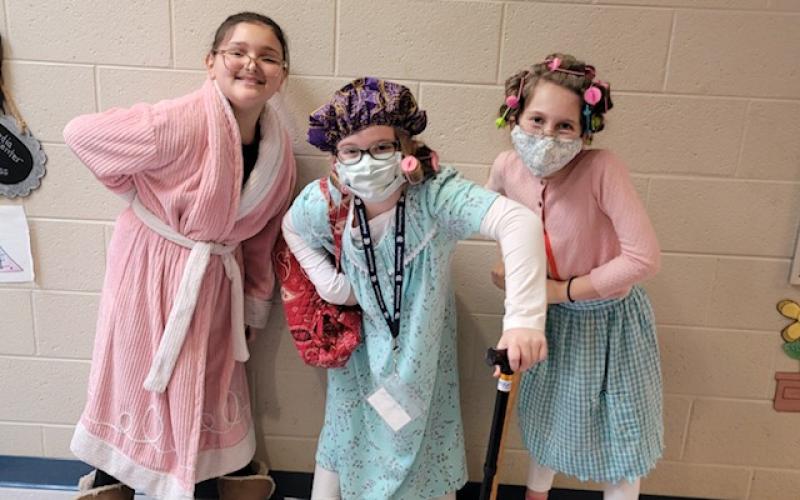Fourth grade students Emily Roberts, Audrey Whitaker, and Harper Murphey dressed up as 100-year-old ladies.  (Submitted photos)