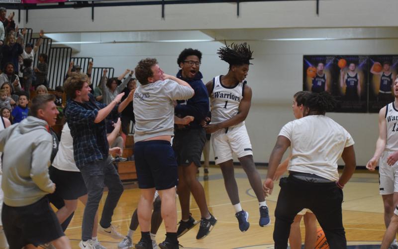 WCHS' Tavi Simmons, right, celebrates with Alex Garcia, left, and Zion McMullen moments after the Warriors knocked off Lakeview-Fort Oglethrope in the opening round of the Class AAA tournament Tuesday in Cleveland. (Photos/Mark Turner)