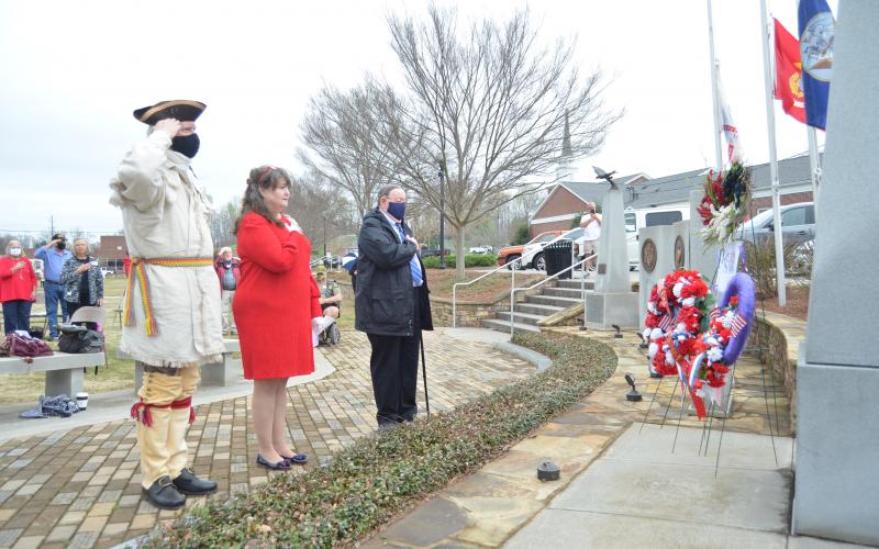 White County’s fallen military service members were honored with a wreath placed at a memorial in Freedom Park during the program. Shown from left are Ed Hendricks, color guard member for the Joseph Habersham Chapter of the Sons of the American Revolution, Cindy Grace, regent for the Tomochichi Chapter of the Daughters of the American Revolution, and Gary Hoyt, veterans committee chairman for the Georgia Society, Sons of the American Revolution. (Photo/Wayne Hardy)