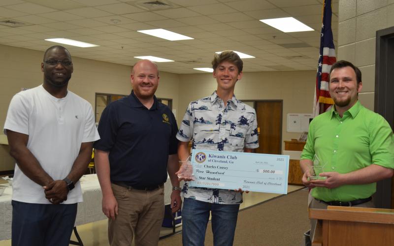 Dr. Octavius Mulligan and Kiwanis President Jason Hogan present plaques to STAR student Charles Causey and STAR teacher Kalin Kennedy. Causey was also presented with a $500 scholarship. Pictured from left, Mulligan, Hogan, Causey and Kennedy. (Photo/Stephanie Hill)