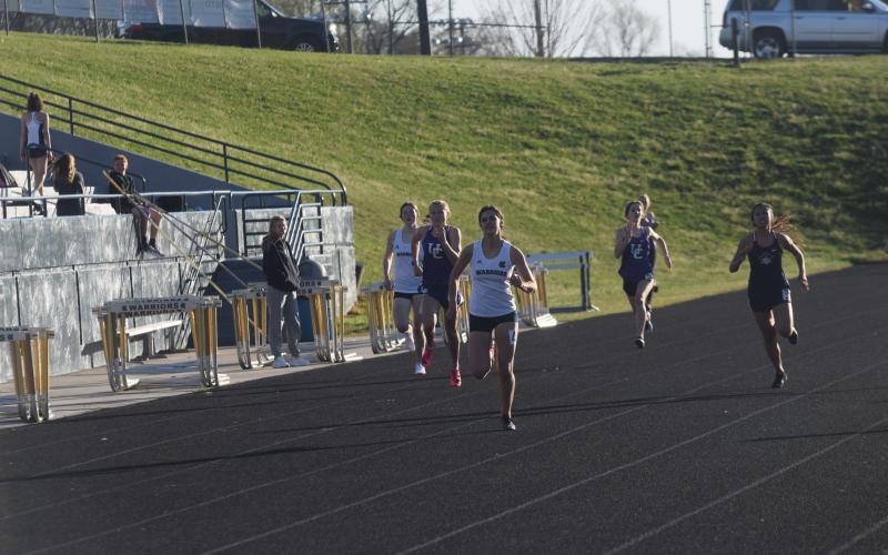 Lily Gearing won a pair of individual events to lead the track teams to the boy's and girl's team titles at the Warrior Invitational last Friday in Cleveland. 