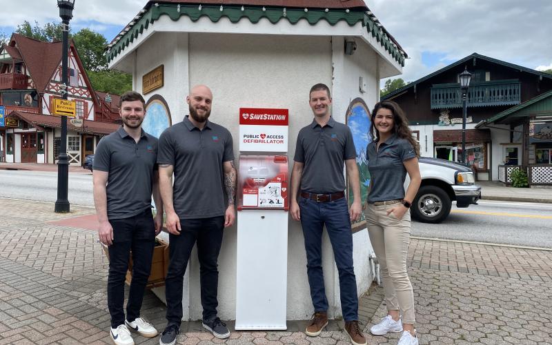 Tyler Richie, Rex Burch, Chris Griesser and Sara Lezcano, with Student Doc for Shocks, pose with the new AED in the marketplatz in downtown Helen. (Photos/Stephanie Hill)