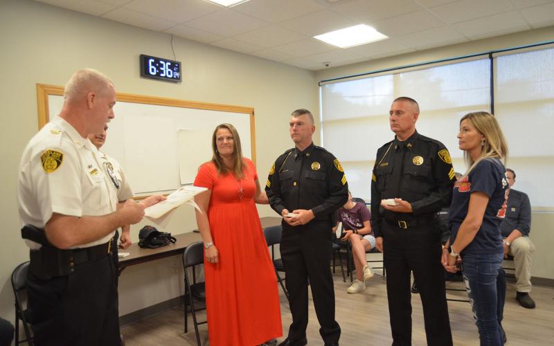 Two Cleveland Police Department officers were recently named sergeants. The recognition and pinning was held at the June 7 Cleveland City Council meeting. Police Chief Jeff Shoemaker (far left) is shown addressing the new sergeants, from left, Wesley Addis and Denton Vaughan. Addis’ wife, Sheila, and Vaughan’s wife, Amy, were on hand to assist with the pinning. (Photo/Wayne Hardy)