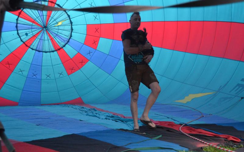 The 48th annual Helen to the Atlantic Balloon Race and Festival wowed the crowds during the showcase, held June 3-5. Pilot Jonathan Wright is shown inside a balloon during inflations last Thursday, holding his dog, Wicket. (Photo/Wayne Hardy)
