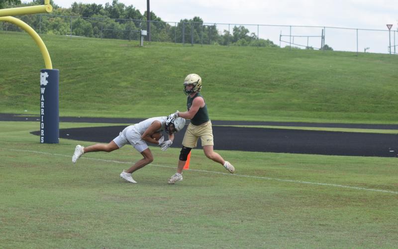 Kanaan Cleveland, left, shown hauling in a touchdown pass  during a 7-on-7 game earlier this summer, and the rest of the Warriors spent two day this week at an FCA Team Camp at Jacksonville State University in Alabama.  (Photo/Mark Turner)
