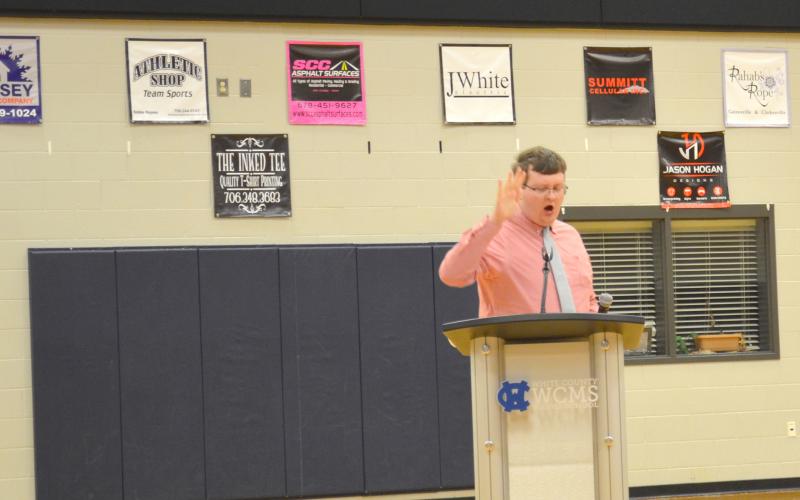 James King was among the members of a citizens group that have made claims that support for critical race theory is being allowed into the school system. King is shown punctuating his remarks by slapping his hand on the speaker’s podium. 