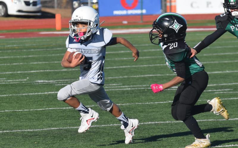 Cash Lowery heads toward the end zone during the fourth grade team's win. (Photo/Mark Turner)
