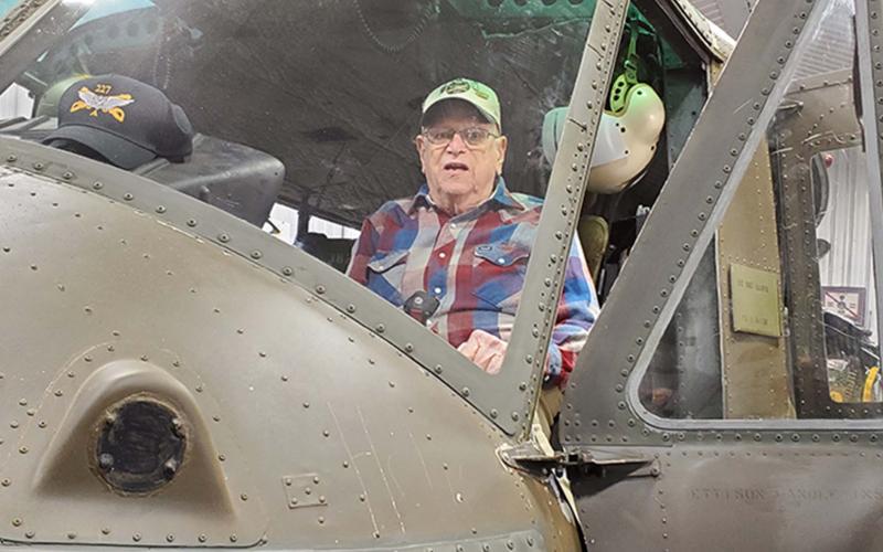Veteran Don Vickery sits in his former helicopter, restored for display in Kentucky. Inset photo shows him while in service. 
