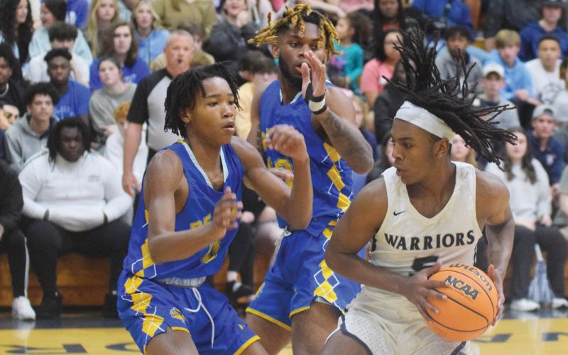 White County's Tavi Simmons, right, works against Beach's James Leach, left, and Jermaine Saxson during the Class AAA second round game Saturday in Cleveland. (Photo/Mark Turner)