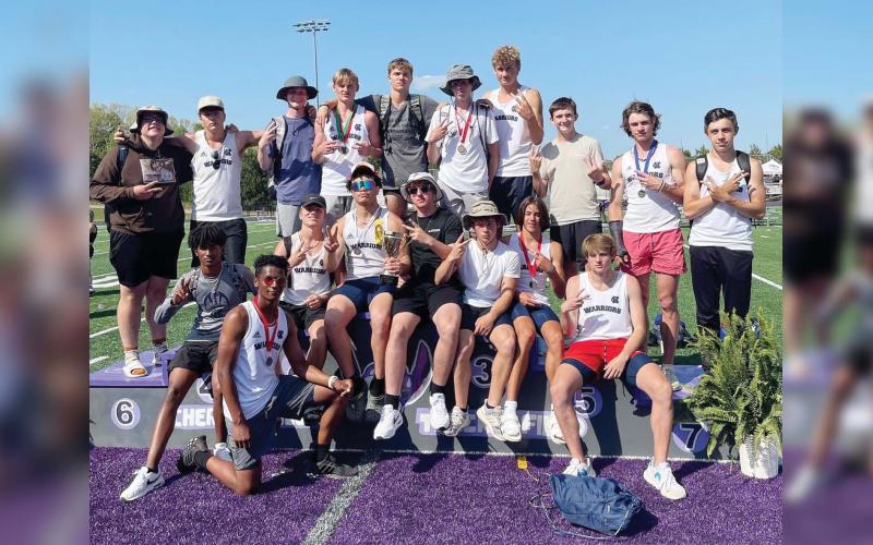The White County Warriors celebrate after winning the Region 7-AAA track championship last Friday at Cherokee Bluff High School. The region title is the second straight for the boy's program. 