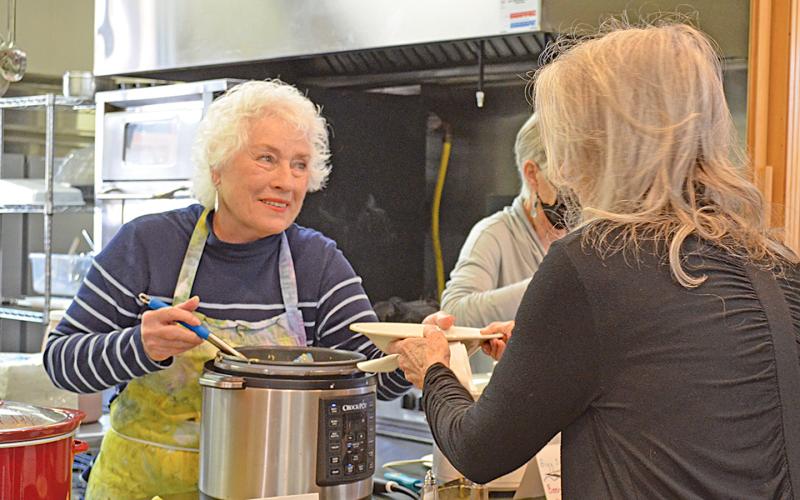 Volunteer Cheryl Oliver serves soup to Carolyn Bralley at Empty Bowls Monday. (Photo/Samantha Sinclair)