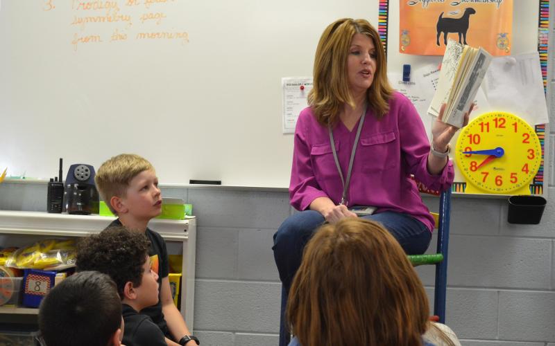 Mt. Yonah Principal Jill Baughman reads to a third grade class Friday afternoon. Many needed to give her hugs before she left the classroom.