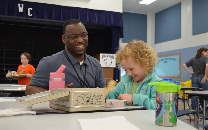 Tesnatee Gap Principal Octavius Mulligan shares a laugh with kindergartner Raleigh Brode in the cafeteria. (Photos/Samantha Sinclair)