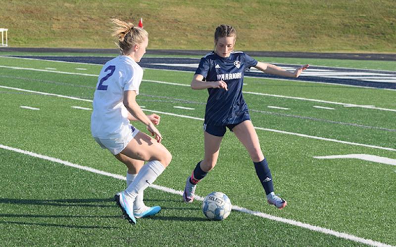 Liz Williams, right, and the Lady Warriors' defensive back line will try to slow down Hebron Christian in the opening round of the Class AAA playoffs.  (Photo/Mark Turner)