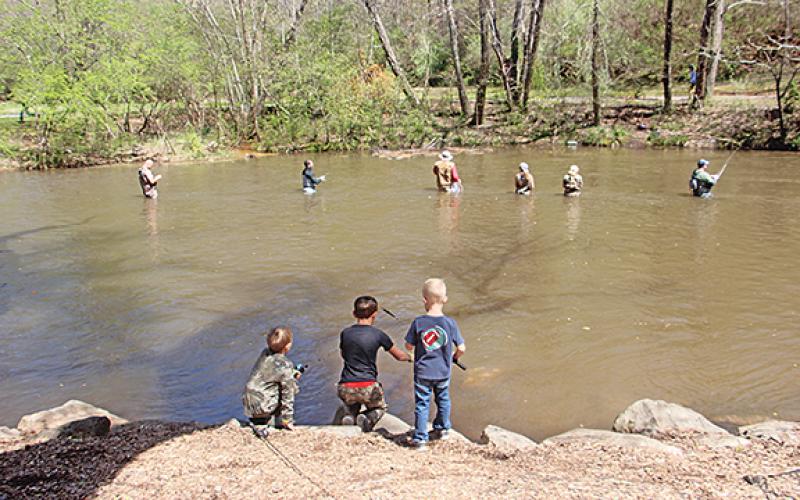 Over 700 contestants registered for this year’s 34th Annual Trout Tournament in Helen over the weekend. Above, the younger generation observes the old on the banks of the Chattahoochee River. (Photo/Jessica Wood)