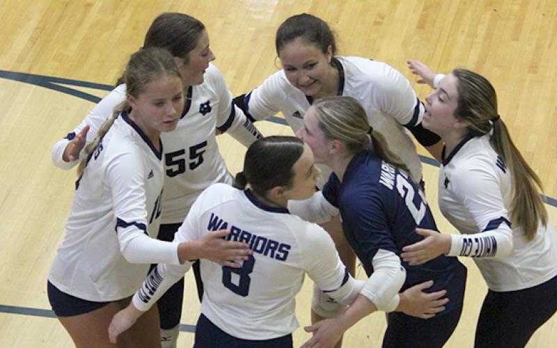 The Lady Warriors celebrate a point during a recent match at WCHS. (Photo/Mark Turner)