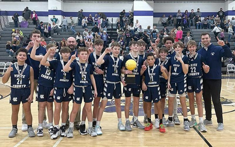The WCMS Warriors show off the tournament hardware after winning the North Georgia Mountain League seventh grade title last week in Ellijay. The Warriors finished the season with a 16-4 record. (Photo/WCMS Athletcis)