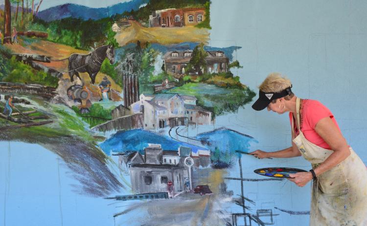 Passers-by along South Main Street in Helen will get a view of a new mural in the works that depicts a century of the community’s history. (Photo/Stephanie Hill)