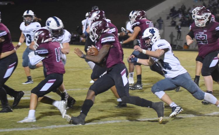WCHS linebacker Jesse Moose, right, runs down Chestatee quarterback Christian Charles during the first half of the region game last Friday night in Gainesville. (Photos/Mark Turner)